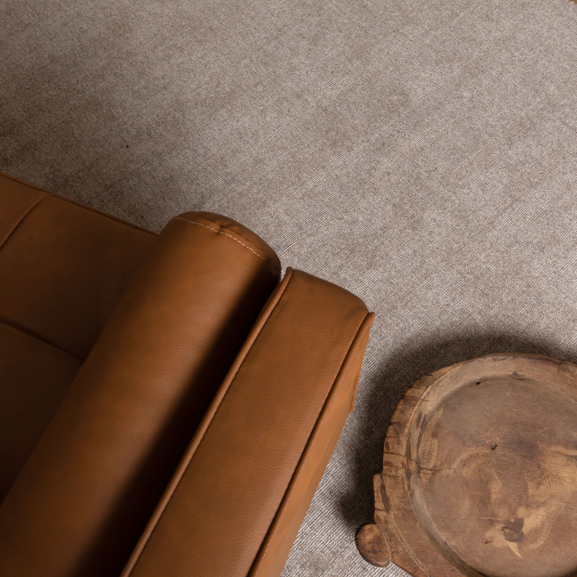 Arizona Camel Wool Rug with tan leather sofa