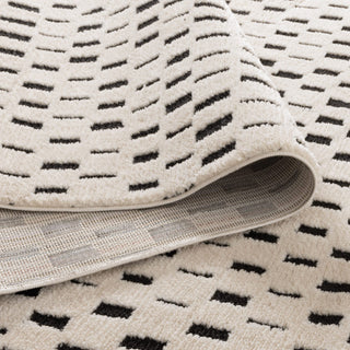 Folded Mila Monochrome Squares Rug showing soft polyester material