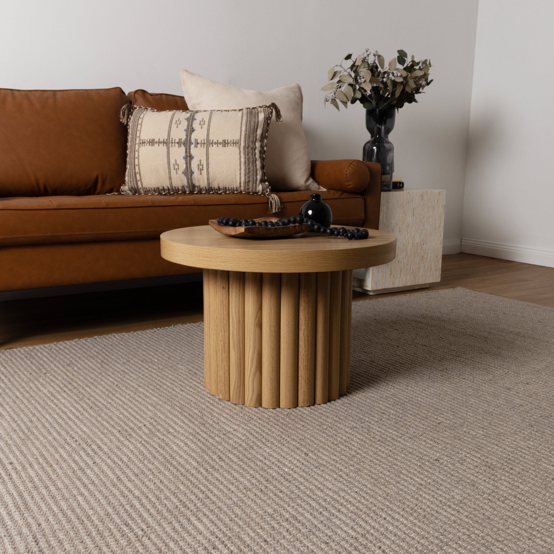 Natura Oatmeal Wool Rug in lounge room with tan sofa