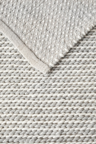 Detailed view of Carina Grey & Ivory Braided Wool Rug - Rustic braided look with soft grey and ivory tones