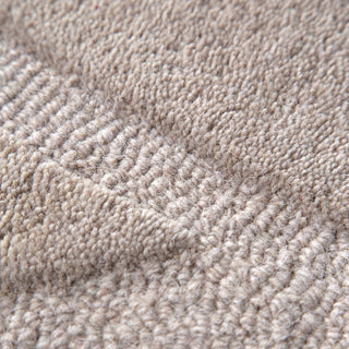 Detailed view of the high low pattern of the Ellipse Beige Wool Rug | Simple Style Co